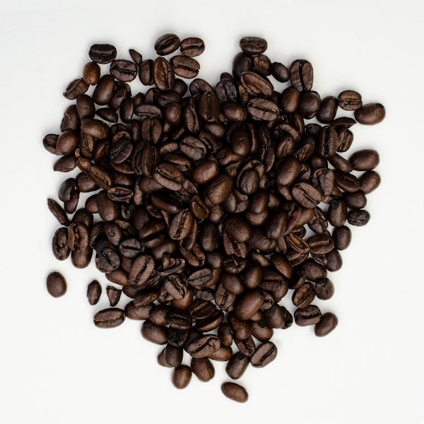 brown coffee beans on white surface