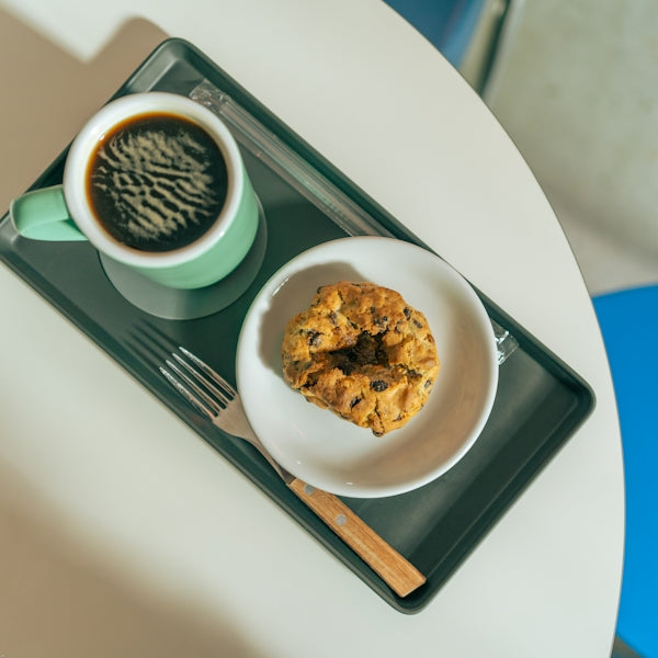 a plate of food and a cup of coffee on a table