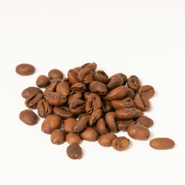 a pile of coffee beans on a white background