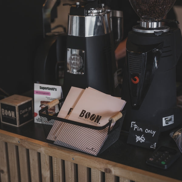 Coffee shop setup with grinders and accessories.