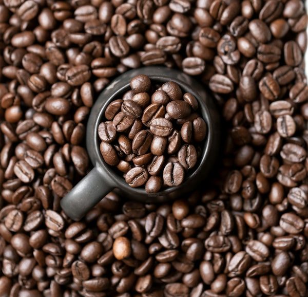 A scoop filled with roasted coffee beans