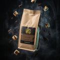 Brown coffee bag with a brand logo on a dark background with floating coffee beans and smoke.